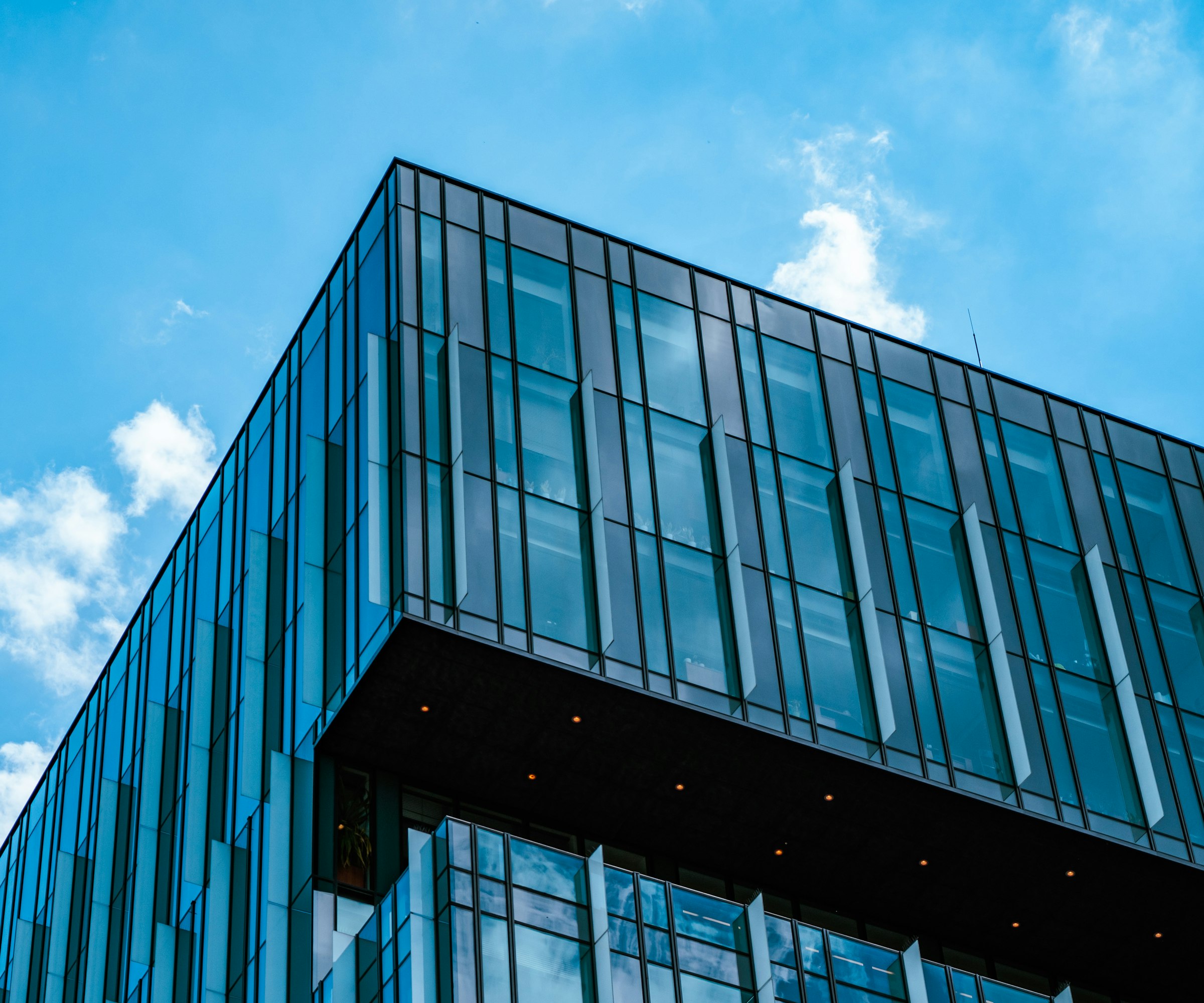 Modern glass architecture representing private equity portfolio businesses.