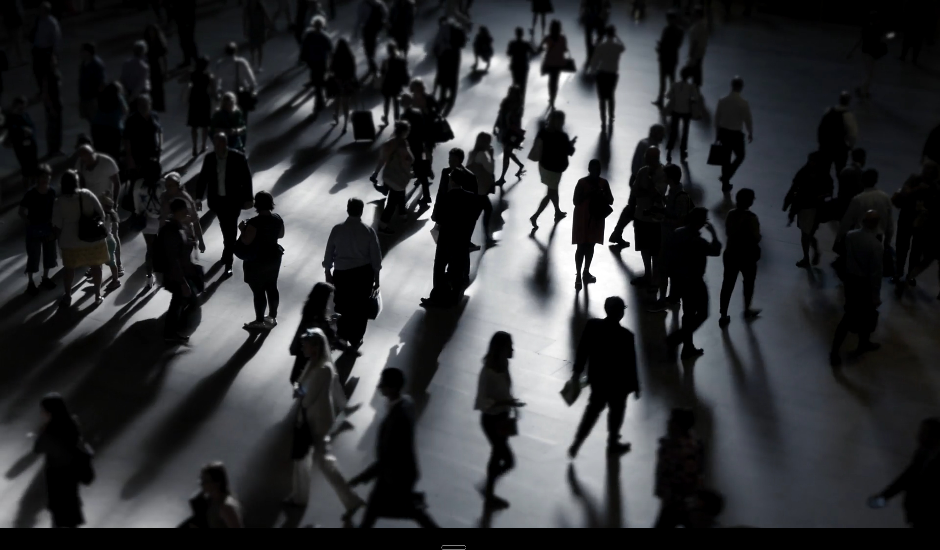 Professionals moving through a large concourse