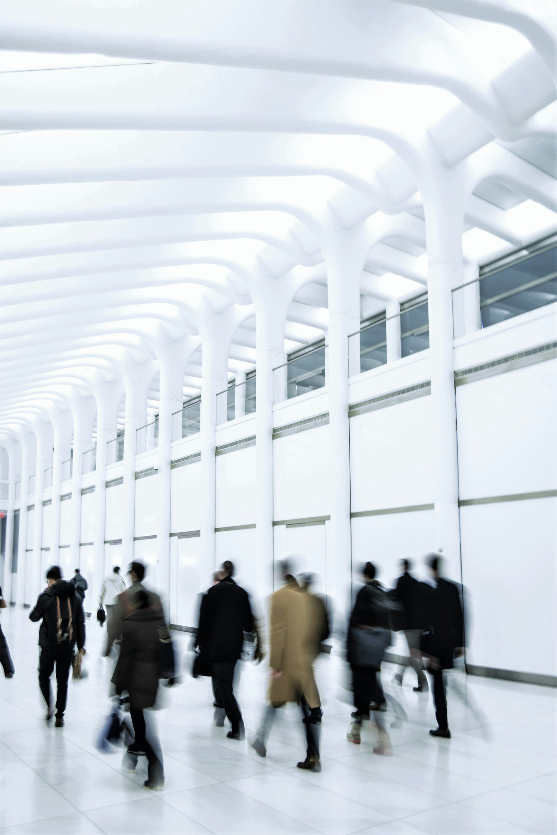 People moving through a bright architectural space